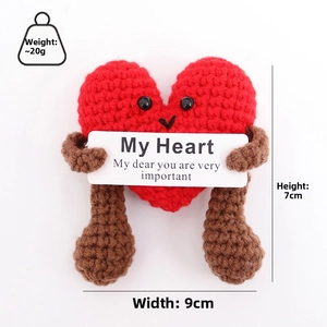 Detail of red knitted heart plush with 7cm height and 9cm width dimensions shown