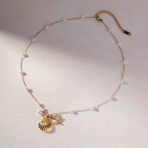 Detail of gold starfish and shell pendants with pearls on a K18 marked necklace