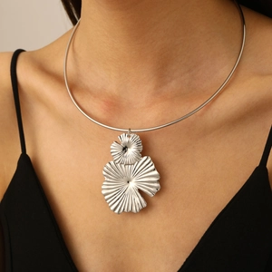 Macro shot of silver vintage flower petal pendant on a sleek choker collar necklace