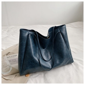 Detailed texture of navy blue PU leather on a large minimalist tote bag for women