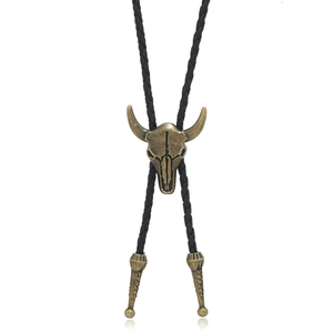 Detail of vintage bull head bolo tie with bronze metal pendant and black braided PU cord