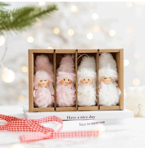 Set of four plush pink and white Christmas gnome ornaments in a wooden divider gift box