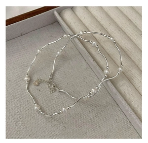 Detail of S925 silver clasp and freshwater pearls on a minimalist vintage bracelet