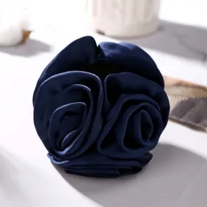 Elegant navy blue satin rose flower hair clip with layered 3D petal design on white background