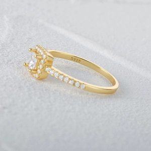 Macro shot of S925 sterling silver ring with halo-set square zircon and paved diamonds