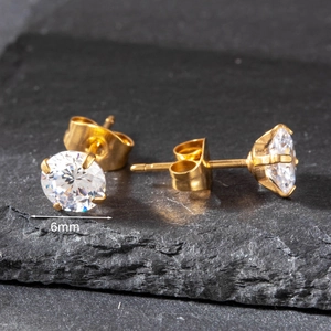 Detailed macro view of a 6mm round cubic zirconia stud earring with four-prong gold setting