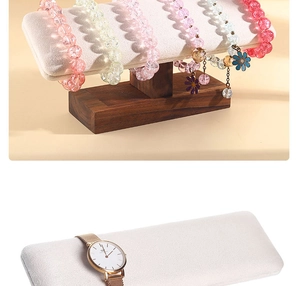 Detailed view of wood bracelet holder with beige velvet watch pillows for jewelry display