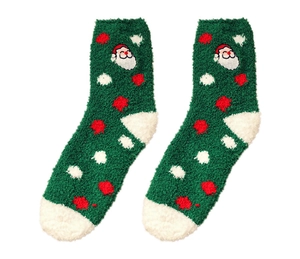 Close-up of green coral fleece socks with Santa embroidery and red polka dots for winter