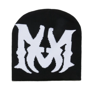 Detailed close-up of a black knit beanie featuring white MM jacquard lettering pattern