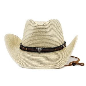 Detail of woven straw cowboy hat with leather band, metal studs and bull head emblem