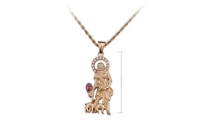 Macro view of 18k gold plated pendant with red gemstone measuring 52x22mm