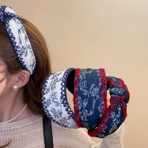 Detail of floral printed wide knot headbands with decorative zigzag edge stitching for women