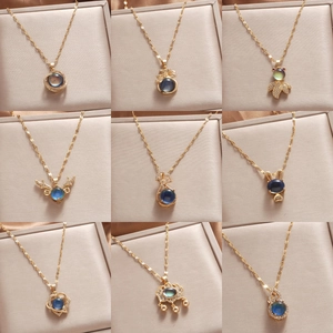 Detailed grid of nine golden necklaces featuring dark blue stones and zircon accents