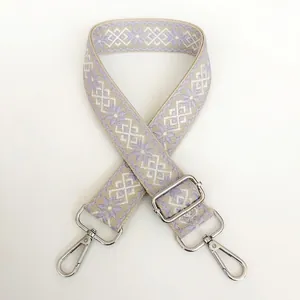 Detail of 3.8cm wide woven geometric strap with silver metal hooks and buckle