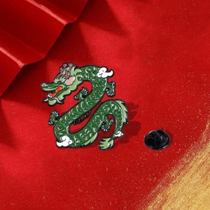Green Chinese dragon enamel pin with black rubber clasp on festive red background