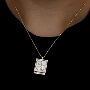 Vintage gold necklace with moon shell pendant and beaded chain shown on a model