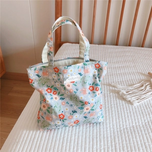 Close-up of floral canvas tote bag showing the zipper closure and Animal patterns label