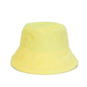 Detail shot of bright yellow faux fur bucket hat with soft plush texture for winter
