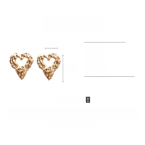 Detail view of retro gold heart earrings with ripple texture, 4cm width and 4.6cm height
