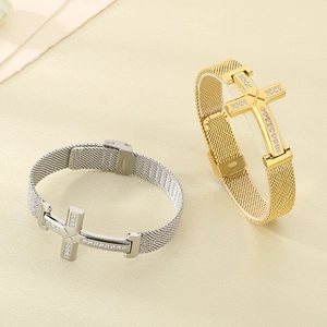 Detail of cross charm bracelets in gold and silver finish with mesh band straps