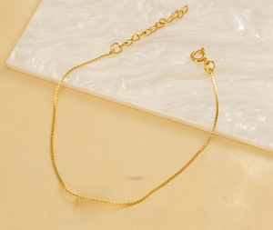 Detail view of gold stainless steel H-pendant bracelet with adjustable lobster clasp