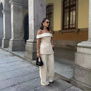 Women's off-shoulder top and wide-leg trousers set in cream woven fabric outdoors