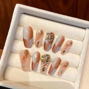 Handmade press-on nails set in long coffin shape with gold foil and 3D rhinestones