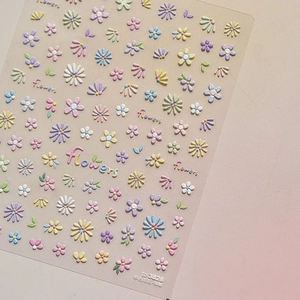 Detailed macro shot of 3D colorful flower nail stickers with embossed floral textures