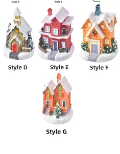 Detail showing seven resin Christmas house miniatures with glitter snow and holiday decor