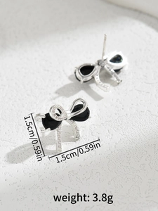 Detail shot of bow earrings with black gems and micro-pavé crystals, 1.5cm size