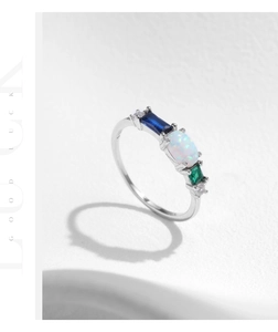 Detailed macro of S925 silver ring featuring oval opal and multi-color gemstones