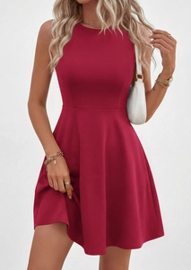 Detail of deep red sleeveless waist dress showing high-quality fabric and gold accessories