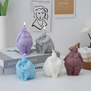Artistic female body torso candles in purple and white colors for home shelf decor