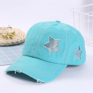 Detail of distressed light blue cotton baseball cap with silver sequin star embroidery