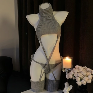 Detailed view of grey knit backless sweater bodysuit with matching stockings and garter