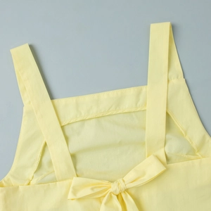 Detail of yellow tank top back featuring wide straps and a centered bow tie design