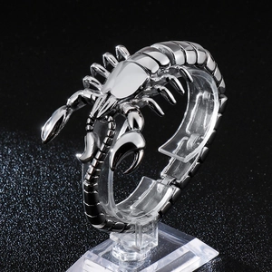 Detailed close-up of a silver street-style scorpion bracelet with engraved metal details