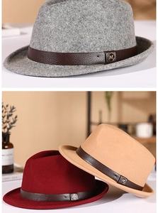 Detailed macro view of wool fedora hats with leather bands and metallic M emblem
