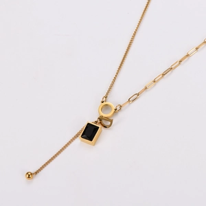 Elegant gold necklace with black square acrylic pendant and interlocking CD charms