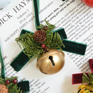 Vintage gold Christmas bell with green velvet bow, pine cones and red berries ornament