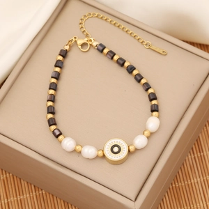 Detailed view of evil eye beaded bracelet with gold accents and lobster clasp