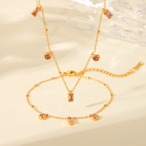Titanium steel jewelry set with pink stones including necklace and bracelet in 18K gold finish