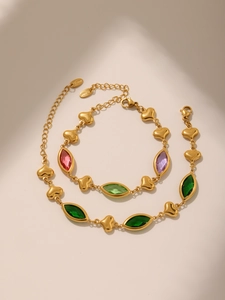 Close-up of 18k gold plated heart bracelets with colorful marquise glass stones