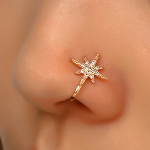Macro shot of gold-plated non-piercing star nose ring with sparkling cubic zirconia