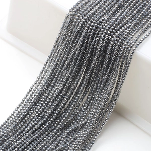 Macro detail of 2mm dark grey faceted glass beads for DIY jewelry making and crafts