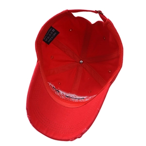 Distressed red 100% cotton baseball cap showing internal structure and wash label