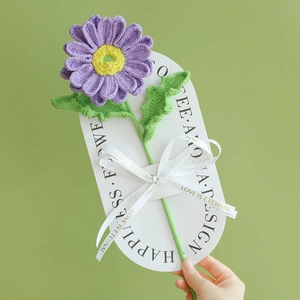 Handmade knitted purple African daisy flower bouquet with decorative white card and ribbon