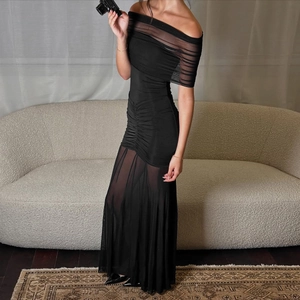 Detail view of black off-shoulder mesh patchwork dress with a slim fit silhouette