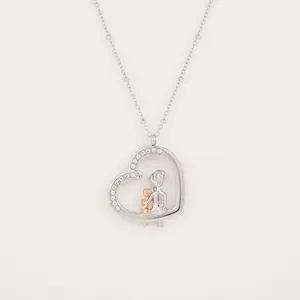 Detailed view of silver heart pendant necklace with crystal inlay and rose gold accents