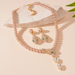 Elegant pearl necklace and earrings set with crystal snake head and teardrop pendants